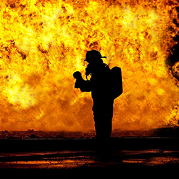Image of firefighter in front of flames
