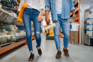 Image of the lower half of a couple walking the aisles of a hardware store.