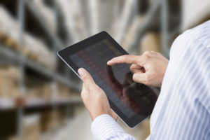 Man operating tablet in a warehouse