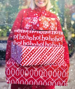 Image of woman carrying Christmas packages.