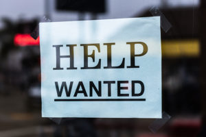 Help Wanted sign in a window.