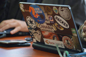 The back of an open laptop being used by a hacker