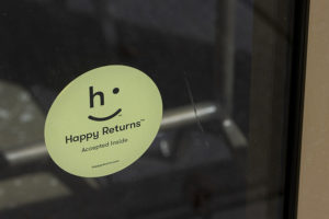 A sticker reading Happy Returns on a store door