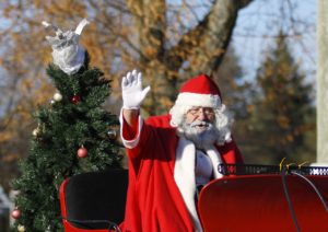 Santa in a parade waving at people