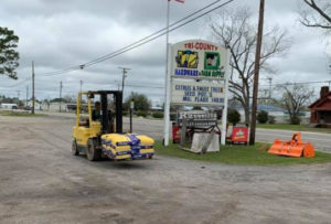 Forklift carrying bags outside Tri-County Hardware