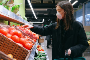 Woman in COVID mask shopping