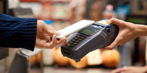 Customer paying for a purchase on a mobile POS device with a cell phone