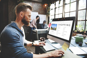 Man online shopping at a desktop computer
