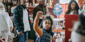 Holiday shopping - Young girl admiring a Christmas ornament
