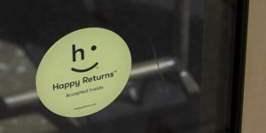 Happy Returns sign on retail store door