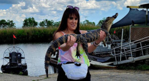 Paladin Client Experience Specialist Alex Smith holding a small alligator