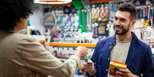 Customer paying with credit card to hardware shop worker