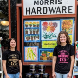 Girls in front of Morris Hardware Art Show display