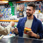 Hardware store customer paying for a rewards program purchase.