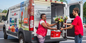 A Proctor Ace Hardware driver delivering flowers.