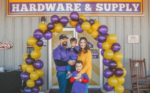 Trent and Diana Taylor and their boys in front of South Beau Hardware & Supply