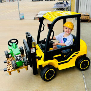 One of the Taylor boys in a toy forklift