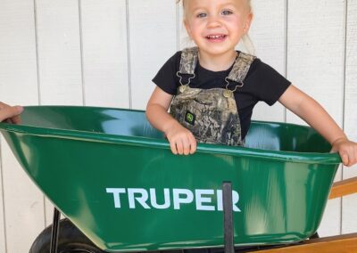 Ben and Allyssa Honeycutt's daughter in a wheelbarrow