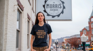 Morris Hardware co-owner Shayna Roberts next to the store sign.