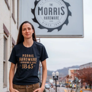 Morris Hardware co-owner Shayna Roberts next to the store sign.