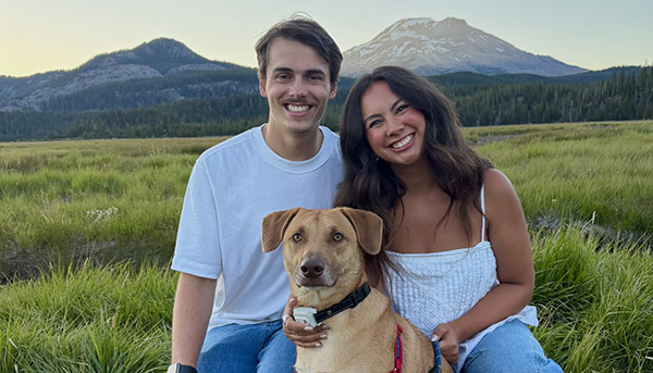 Paladin TSR Joven Kvortek, his wife, Marissa, and their dog Walter, with the Three Sisters Wilderness in the background.