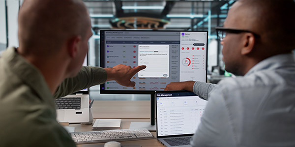 Two engineers look at Data Using Advanced Software Tools.