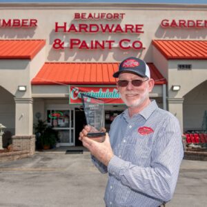 Beaufort Hardware & Paint owner Tommy Simpson holding his 2026 Beacon Award